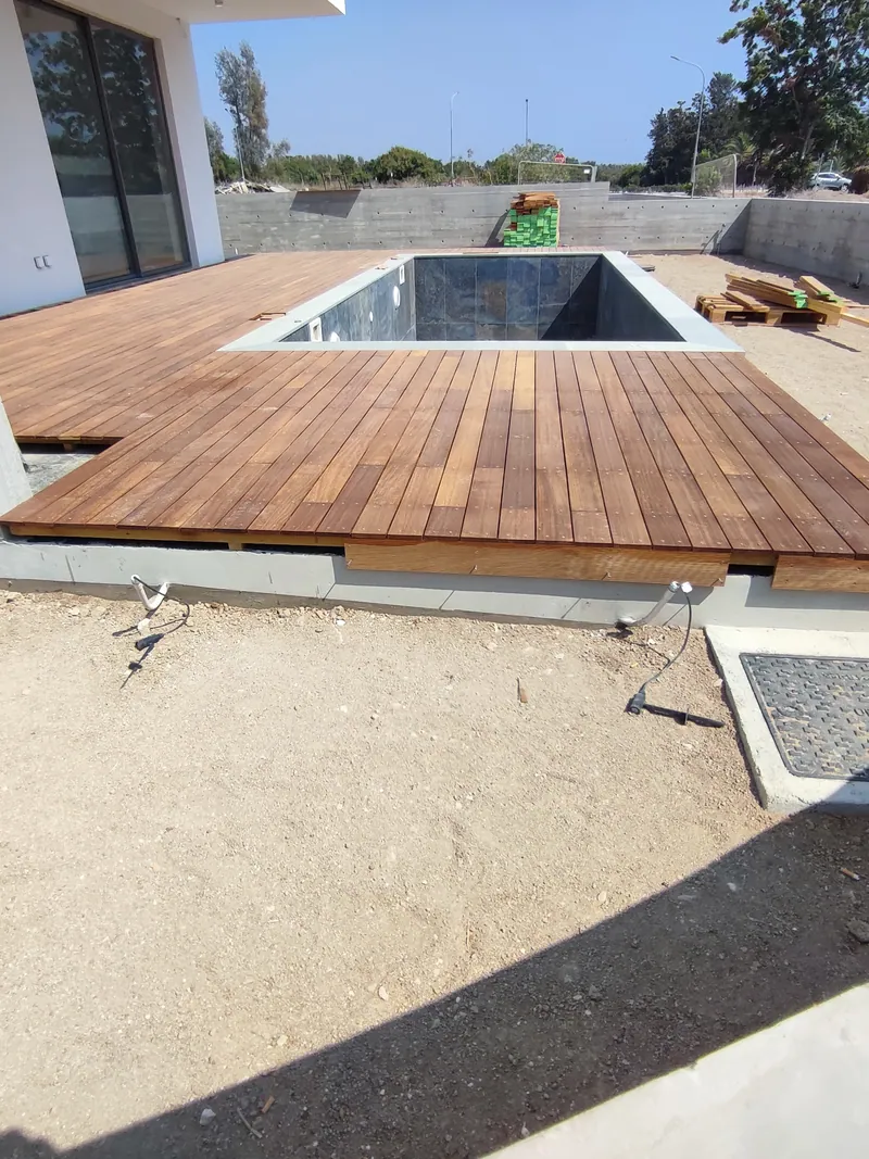 Before: the new pool and timber deck, surrounded by bare sand