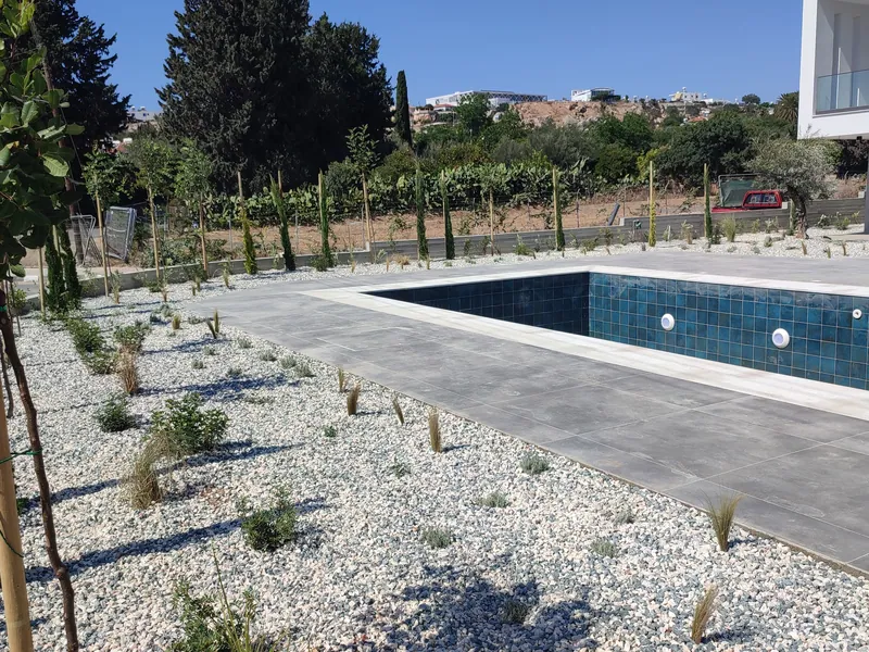 After: gravel beds of young grasses and shrubs around the pool