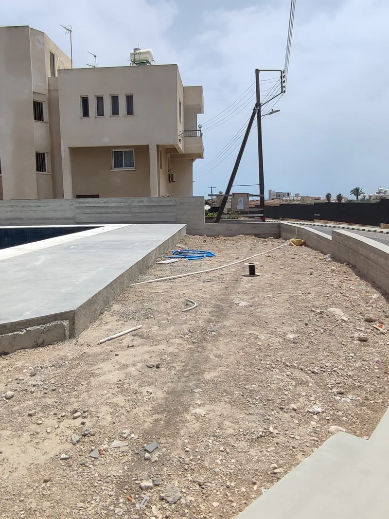 Before: the bare bed along the street beside the pool terrace