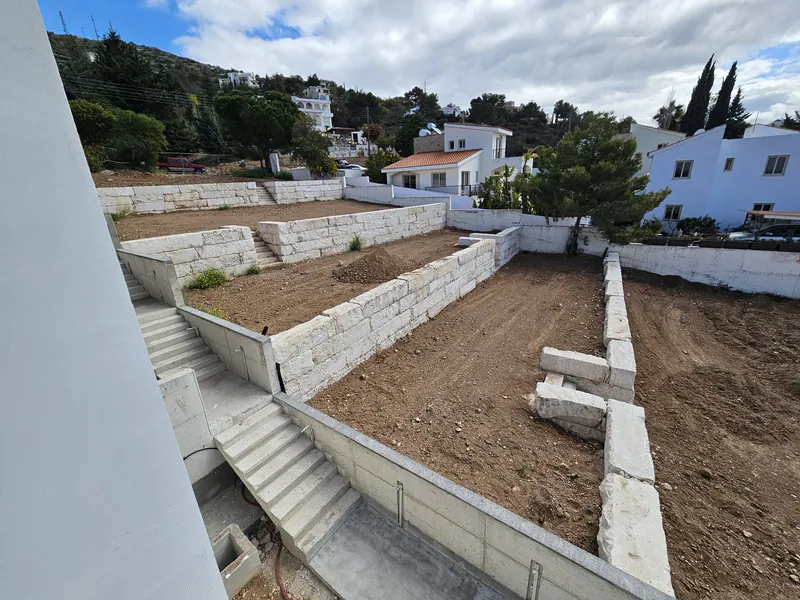 Before: bare soil on the terraces below the balcony