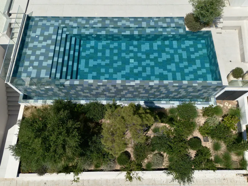 Looking down on the mosaic-tiled pool and the planted bed below it