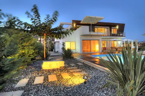 A private garden designed by Antoine Garden Designer, Paphos — pools & sea, by night