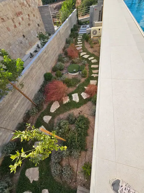 A private garden designed by Antoine Garden Designer, Paphos — paths, pools & sea, its irrigation in view