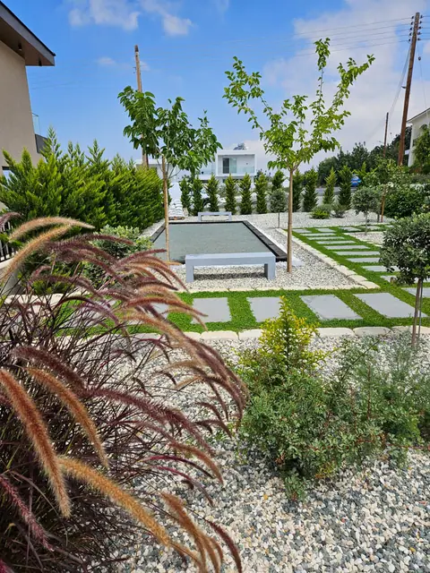 A communal garden designed by Antoine Garden Designer, Paphos — grasses